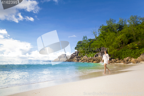 Image of A beautiful woman walking on the beach