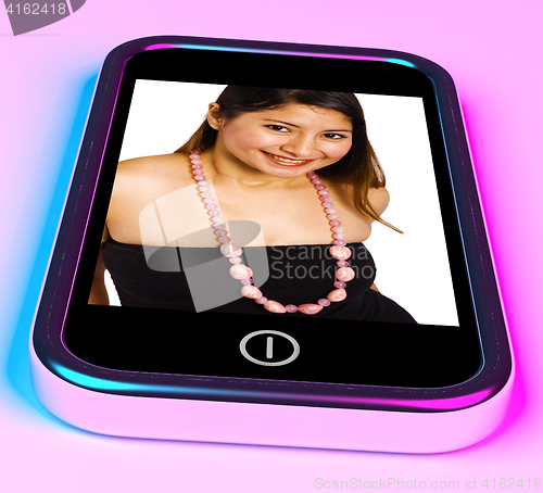 Image of Happy And Smiling Young Woman Photo On A Mobile Phone