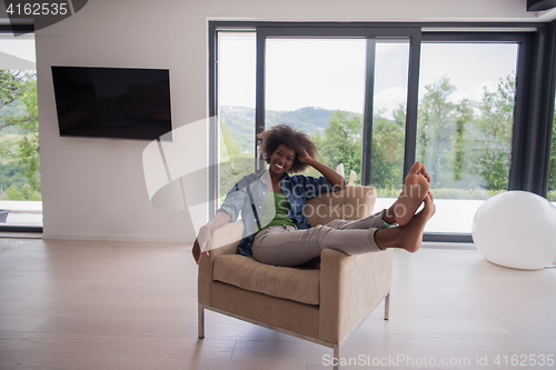 Image of black women at home in the chair