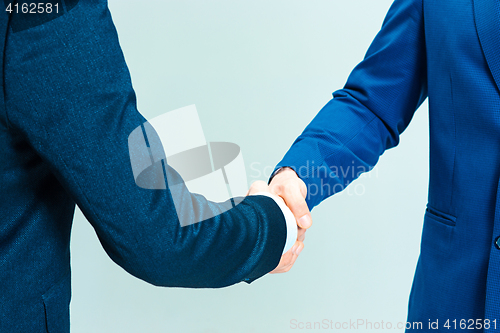 Image of handshake isolated on gray