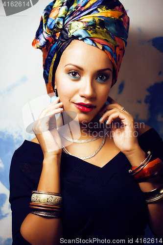 Image of beauty bright african woman with creative make up, shawl on head