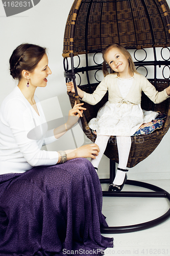 Image of young mother with daughter at luxury home interior vintage
