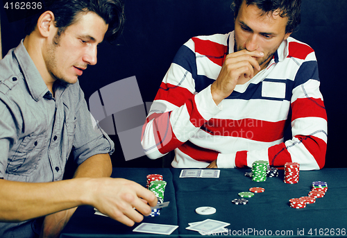 Image of young people playing poker off-line tournament, friends party co