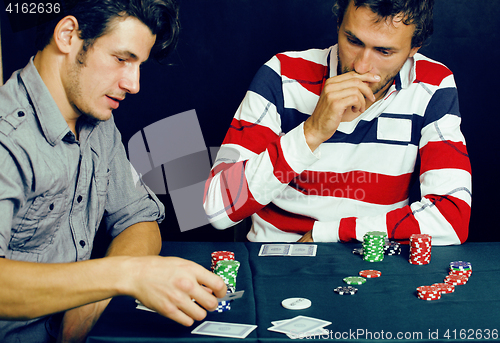 Image of young people playing poker off-line tournament, friends party co