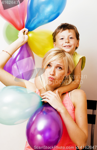 Image of pretty real family with color balloons on white background, blon