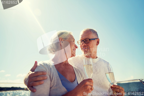 Image of senior couple drinking champagne on sail boat