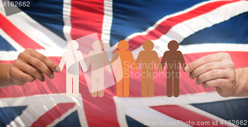 Image of hands holding people pictogram over english flag