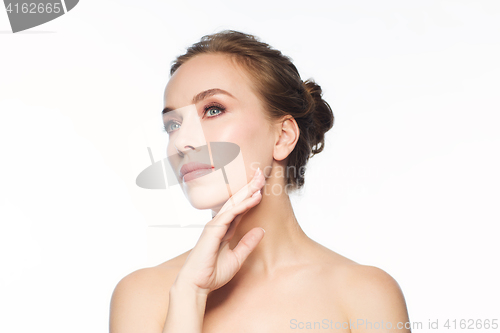 Image of beautiful young woman touching her face