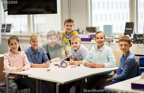 Image of happy children building robots at robotics school