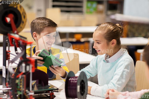 Image of happy children with 3d printer at robotics school