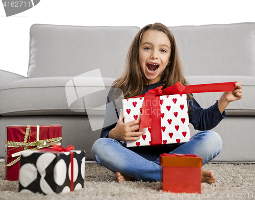 Image of Little girl opening presents