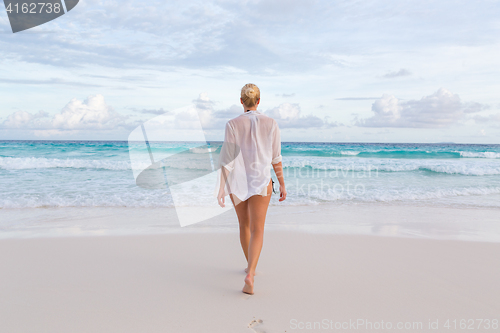 Image of Woman on summer vacations at tropical beach of Mahe Island, Seychelles.