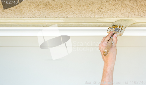 Image of Professional Painter Cutting In With Brush to Paint Garage Door 