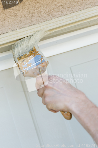 Image of Professional Painter Cutting In With Brush to Paint Garage Door 