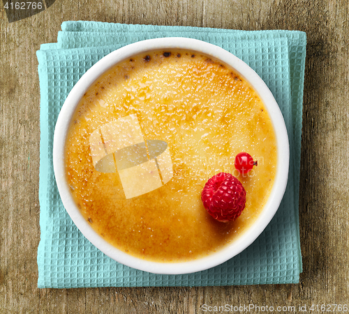 Image of creme brule on wooden background