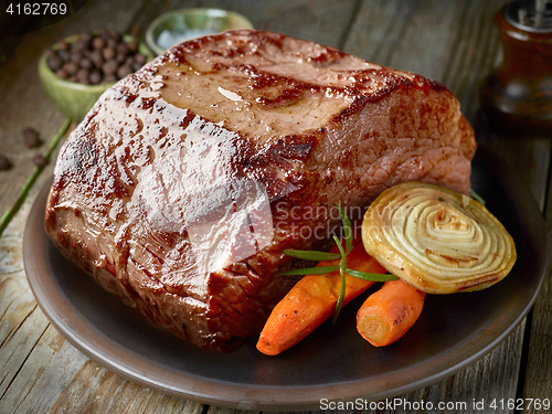 Image of roasted deer on dark plate