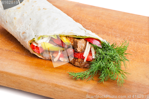 Image of beef burrito with peppers, onion and tomato