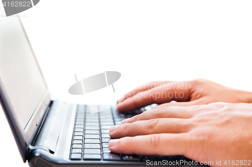 Image of Businessman working on laptop over white