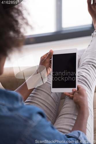 Image of african american woman at home with digital tablet