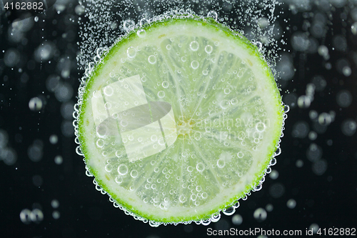 Image of Lime slice falling into water