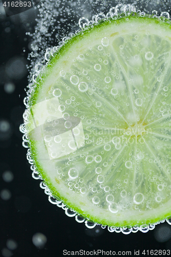 Image of Lime slice falling into water