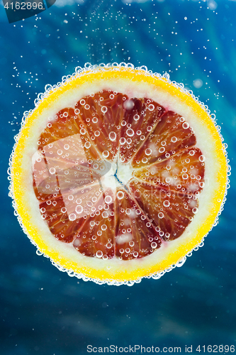 Image of Blood orange slice falling into water