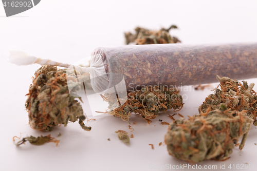 Image of Close up of dried marijuana leaves and joint