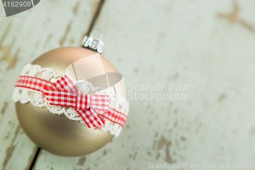 Image of Three Christmas baubles on rustic wood