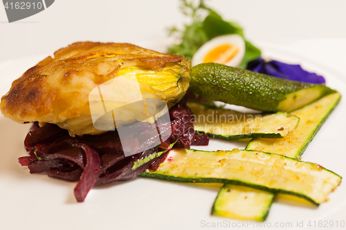 Image of Delicious biscuit with beets, zucchini and pansy