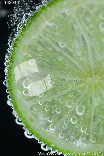 Image of Lime slice falling into water