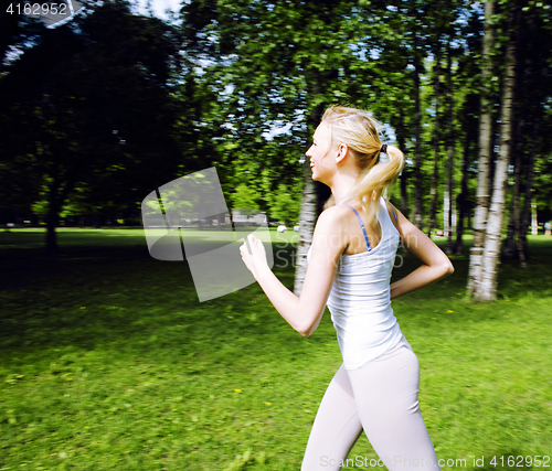 Image of young pretty blond woman doing sport in park in sunny day at summer, lifestyle people concept