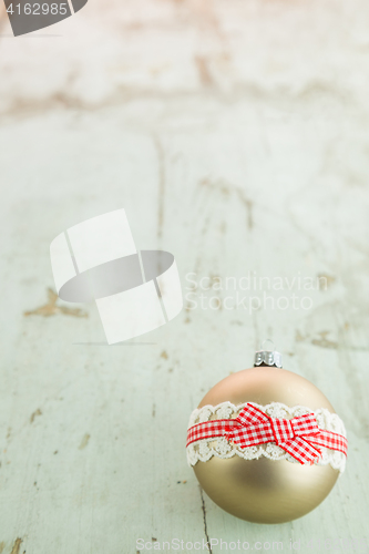 Image of Three Christmas baubles on rustic wood