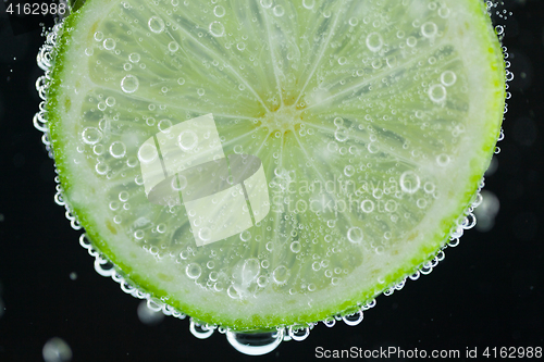 Image of Lime slice falling into water