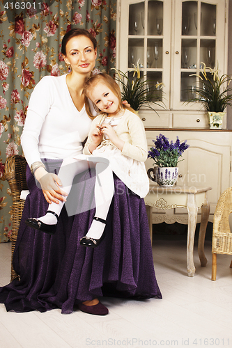 Image of young mother with daughter at luxury home interior vintage