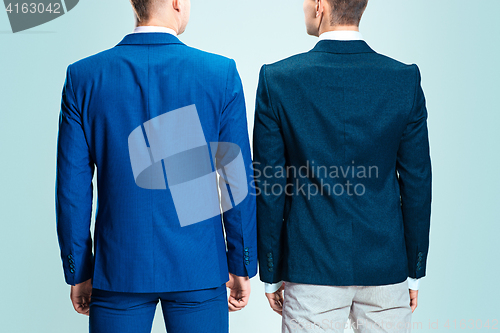 Image of Two young stylish men in a suit. Rear view from the back.