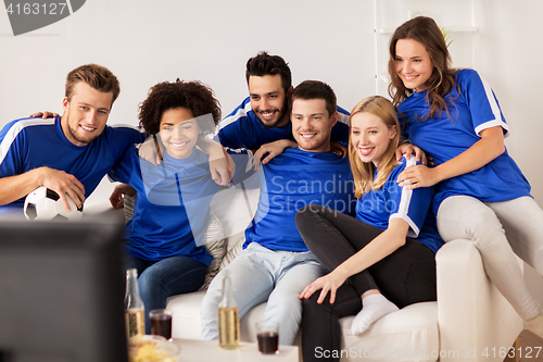 Image of friends or football fans watching soccer at home