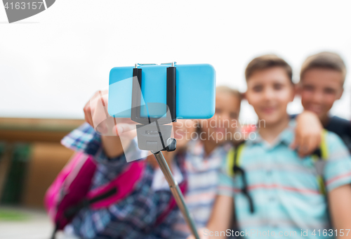 Image of happy elementary school students taking selfie