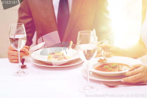 Image of close up of couple eating appetizers at restaurant