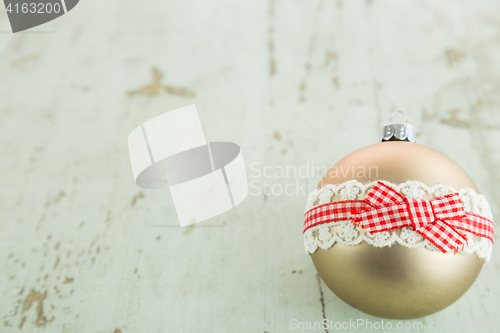 Image of Three Christmas baubles on rustic wood