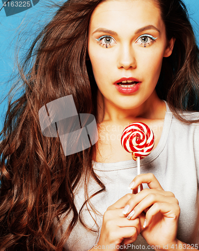 Image of young pretty adorable woman with candy close up like doll