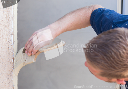 Image of Professional Painter Cutting In With Brush to Paint House Door F