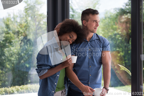 Image of romantic happy young couple relax at modern home indoors