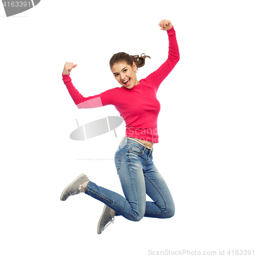 Image of smiling young woman jumping in air