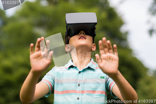 Image of boy with virtual reality headset outdoors