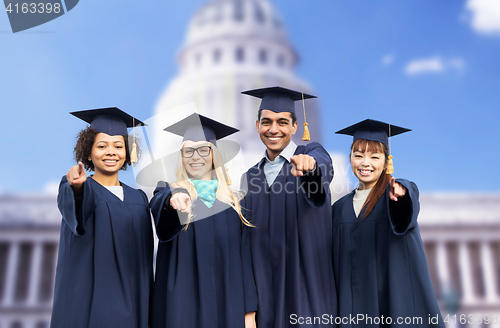 Image of happy students or bachelors pointing finger at you