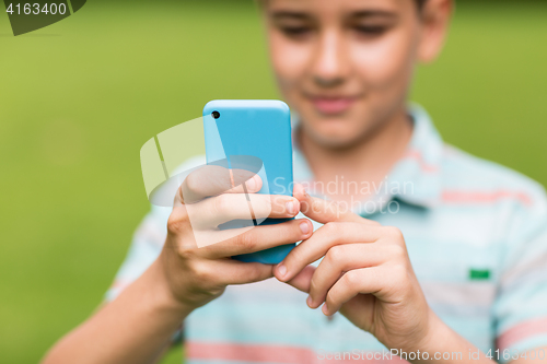 Image of boy with smartphone outdoors at summer