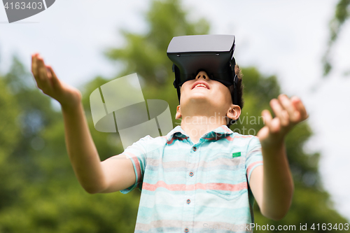 Image of boy with virtual reality headset outdoors