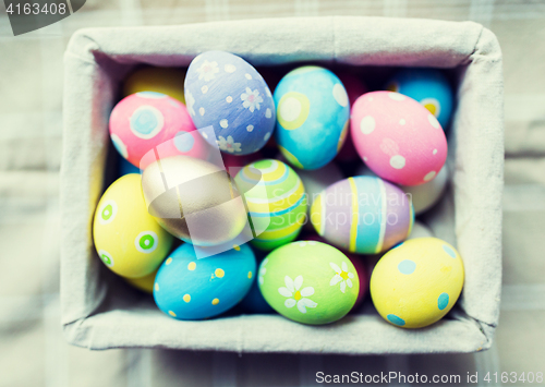 Image of close up of colored easter eggs in basket