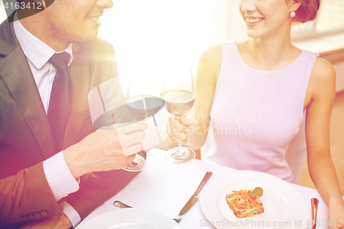 Image of happy couple with glasses of wine at restaurant