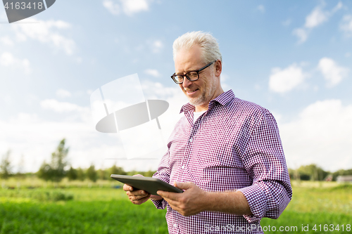 Image of senior man with tablet pc computer at county